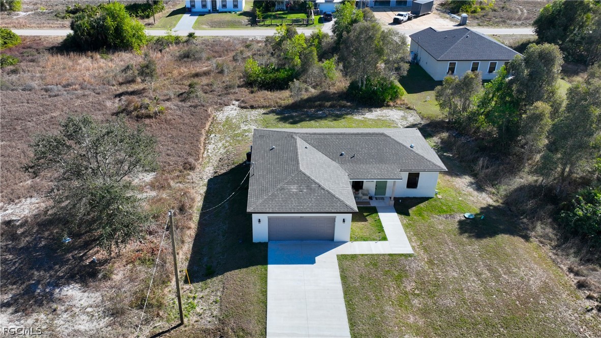 809 Bell Boulevard Lehigh Acres, FL 33974 - Photo 31 of 37 an aerial view of a house with a yard