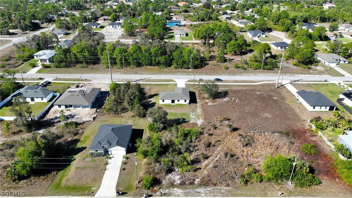 809 Bell Boulevard Lehigh Acres, FL 33974 - Photo 33 of 37 an aerial view of a house with a yard