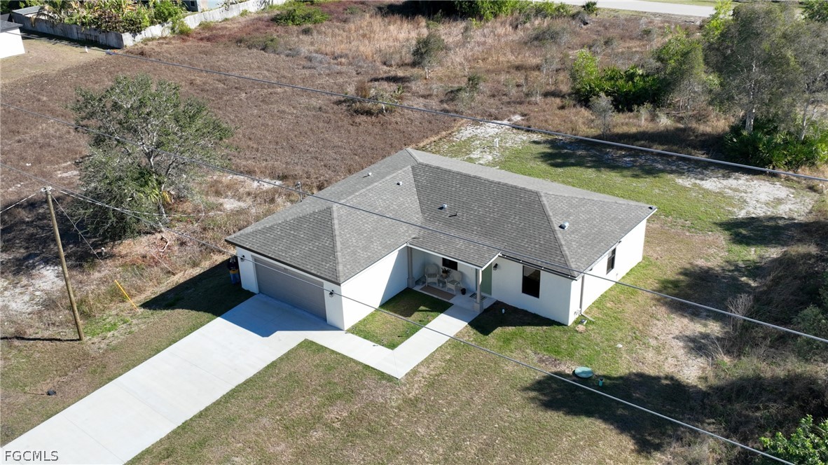 809 Bell Boulevard Lehigh Acres, FL 33974 - Photo 34 of 37 an aerial view of a house with a yard