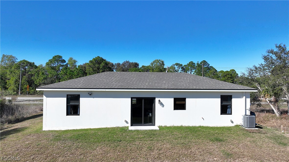 809 Bell Boulevard Lehigh Acres, FL 33974 - Photo 36 of 37 a front view of a house with a yard