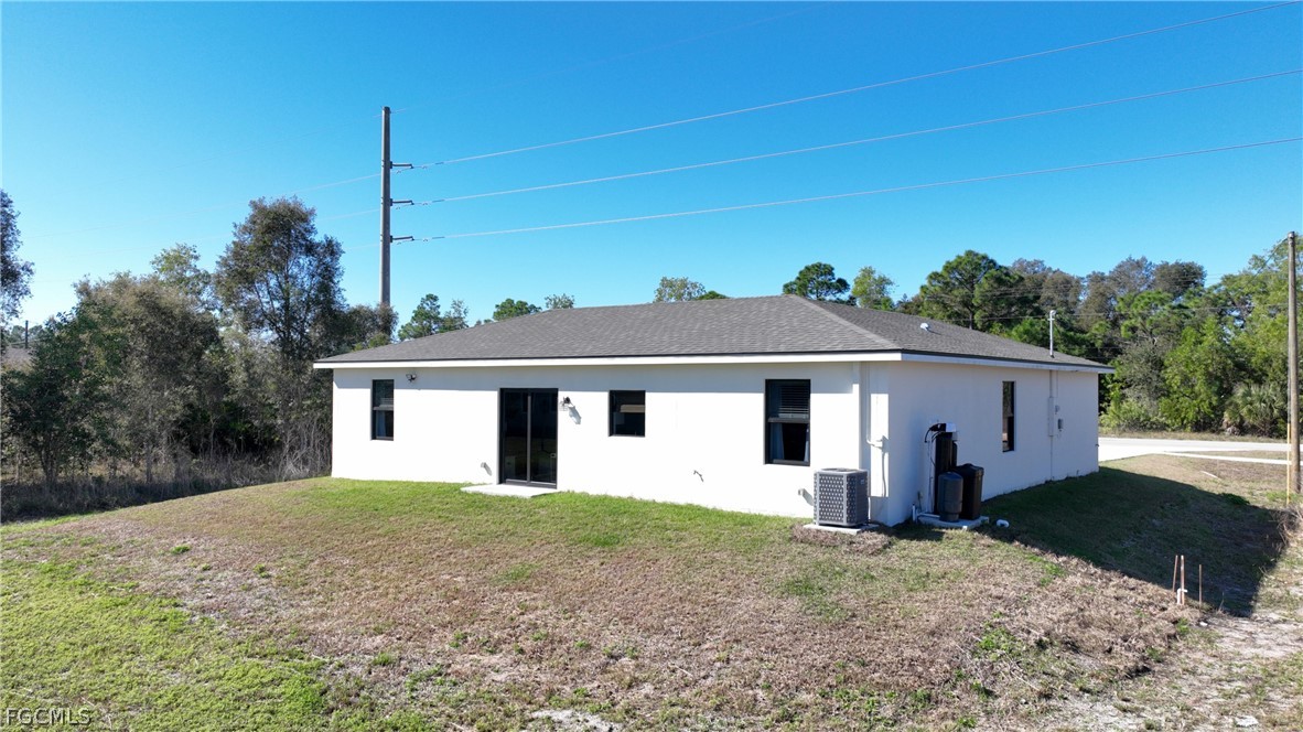 809 Bell Boulevard Lehigh Acres, FL 33974 - Photo 37 of 37 a view of a house with a yard