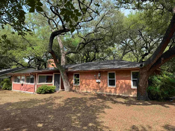 a front view of a house with a tree s