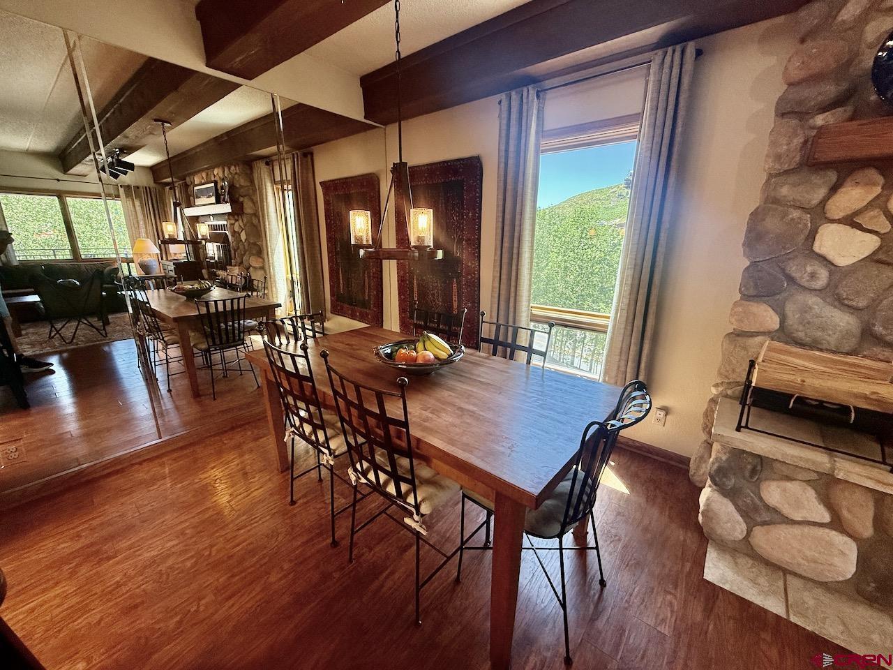 11 Snowmass Road, Unit 337 Crested Butte, CO 81225 - Photo 15 of 35 a view of a dining room with furniture window and wooden floor
