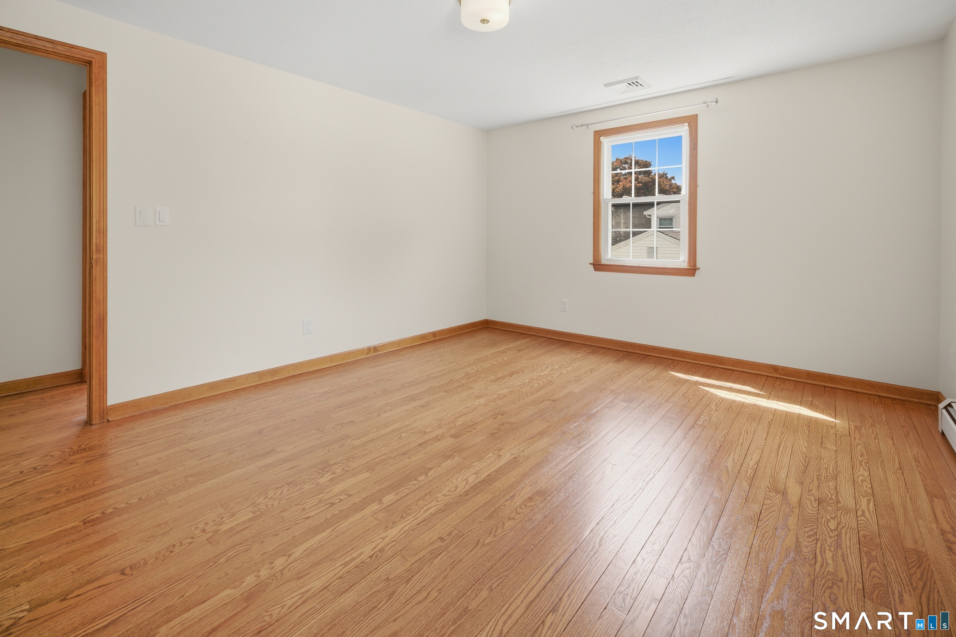 211 Valley View Road Manchester, CT 06040 - Photo 28 of 39 an empty room with wooden floor and windows
