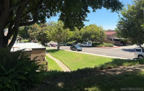 a view of yard with swimming pool and green space