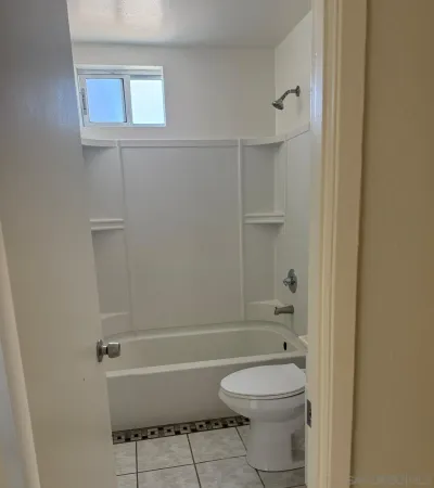 a bathroom with a toilet and a shower