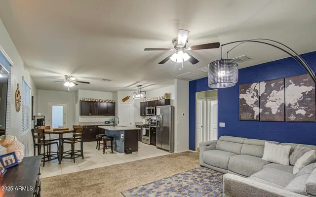 a view of a dining room with furniture and a kitchen