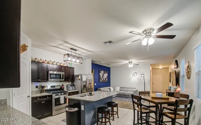 a kitchen that has a table and chairs in it