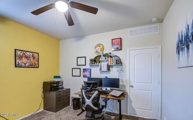 a bedroom with a large bed and a flat tv screen on dresser
