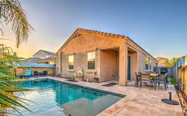 a view of a deck with couches table and chairs with wooden floor