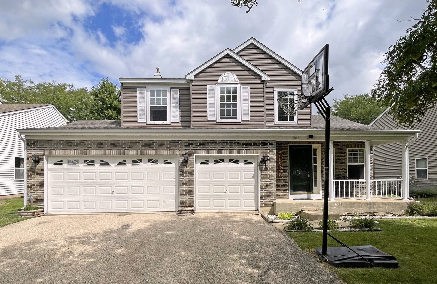 a front view of a house with a yard