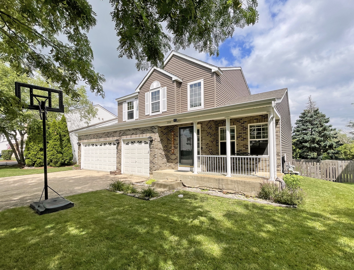 2048 Norwich Drive Bartlett, IL 60103 - Photo 2 of 25 a front view of a house with a yard