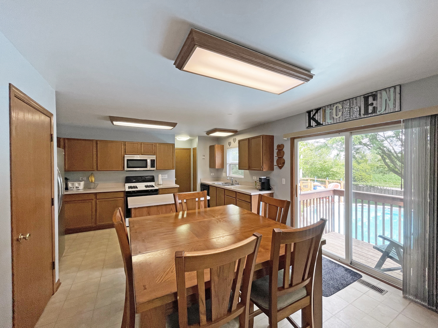 2048 Norwich Drive Bartlett, IL 60103 - Photo 7 of 25 a dining room with furniture and a floor to ceiling window