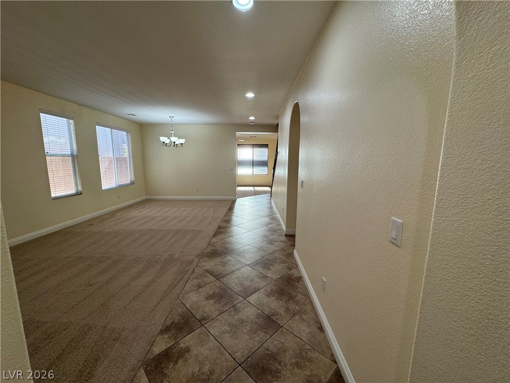 1333 Jamesbury Road Las Vegas, NV 89135 - Photo 7 of 43 Natural light illuminates this spacious living area with combined flooring and architectural details.