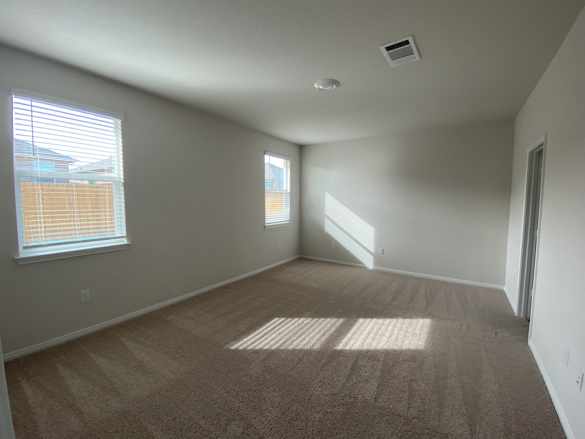 236 Sunniberg Loop Georgetown, TX 78626 - Photo 10 of 22 Generous windows let natural light stream across this comfortable bedroom featuring plush carpeting.