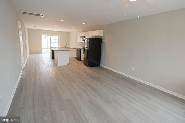 a view of open kitchen with wooden floor and windows