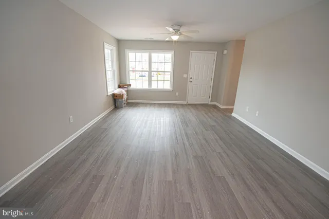 a kitchen with stainless steel appliances a refrigerator and wooden floor