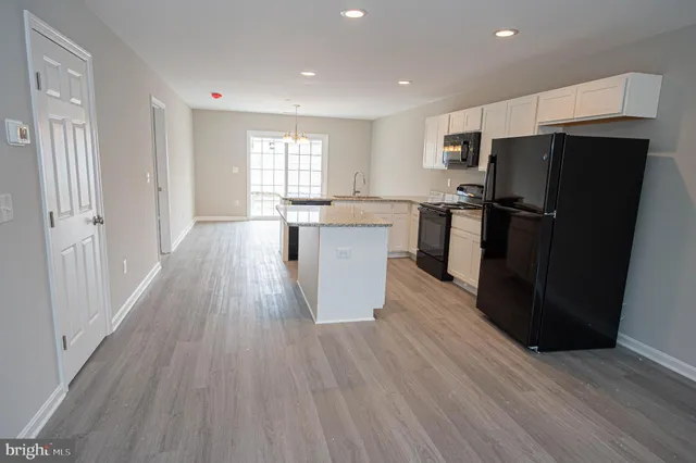 a kitchen with a sink stove and refrigerator
