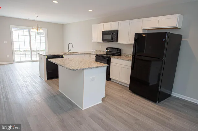a kitchen with a sink and a refrigerator