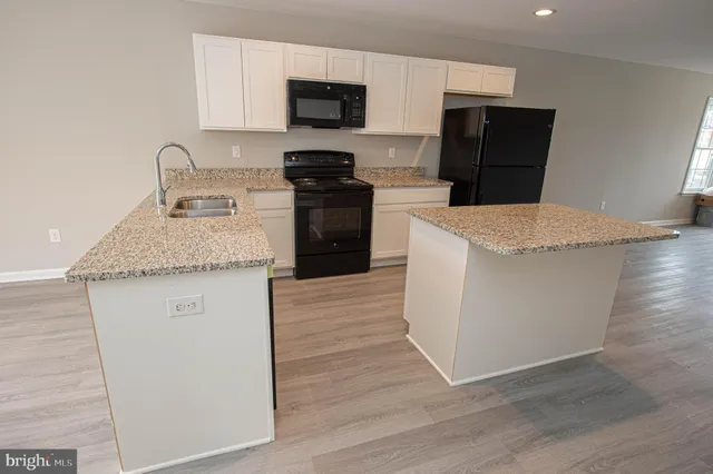 a kitchen with a sink stove and cabinets