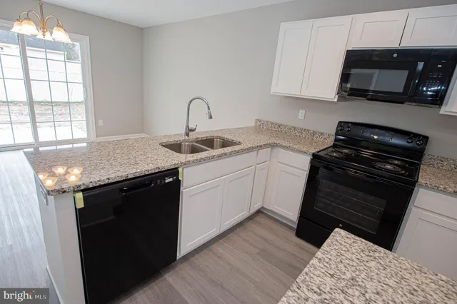 a view of a kitchen with microwave and cabinets