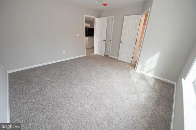 a bathroom with a granite countertop sink a toilet and a mirror