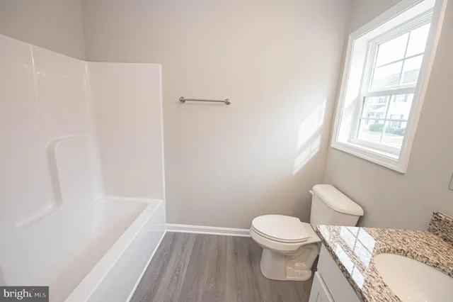 a kitchen with stainless steel appliances granite countertop a sink dishwasher stove top oven and refrigerator