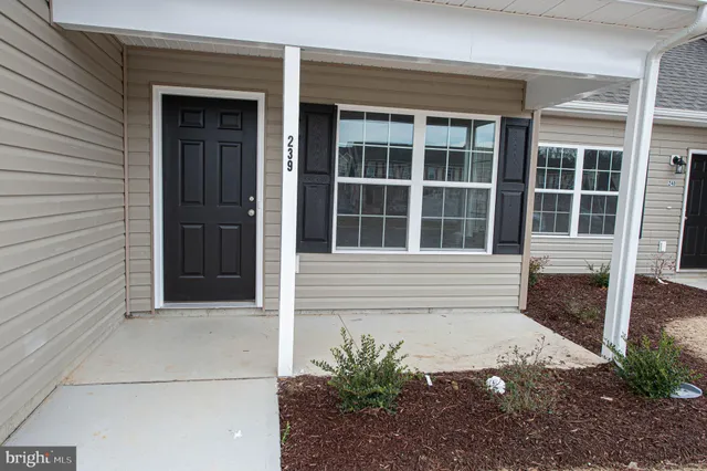 a view of a house with a yard and garage