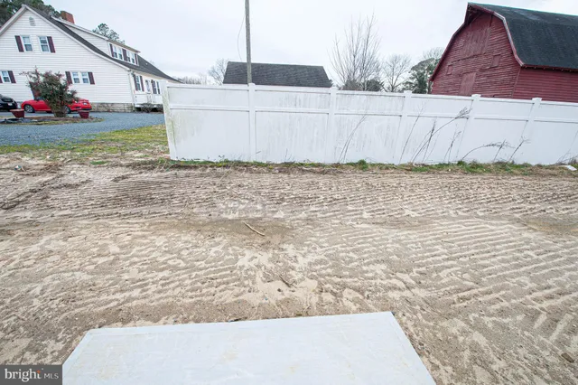 a view of kitchen with refrigerator and wooden floor