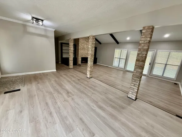 a view of an entryway with wooden floor