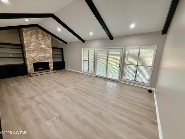 a view of an empty room with a fireplace