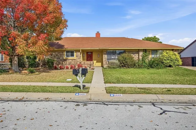 a view of house with yard and green space