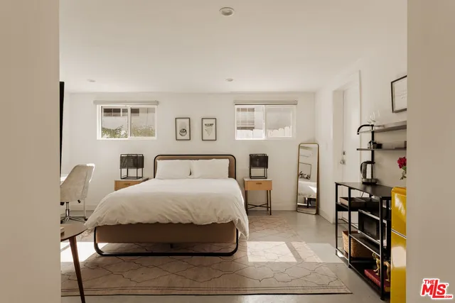 a bedroom with a bed and a book shelf