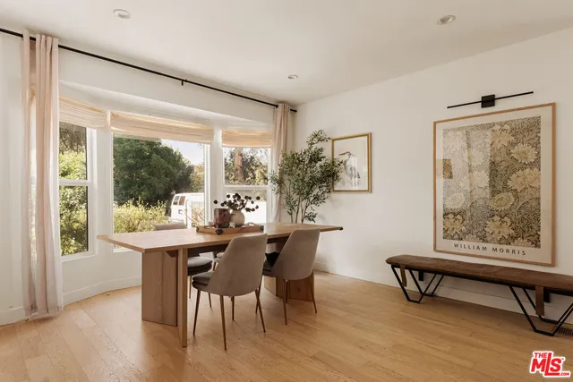 a dining room with furniture and wooden floor