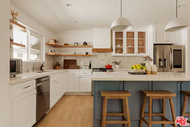 a kitchen with a sink cabinets and window