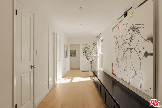 a view of a bathroom with shower and mirror