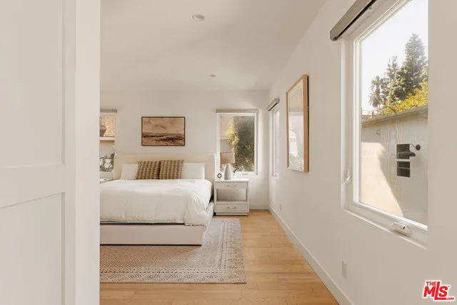 a room with a bed and a large window