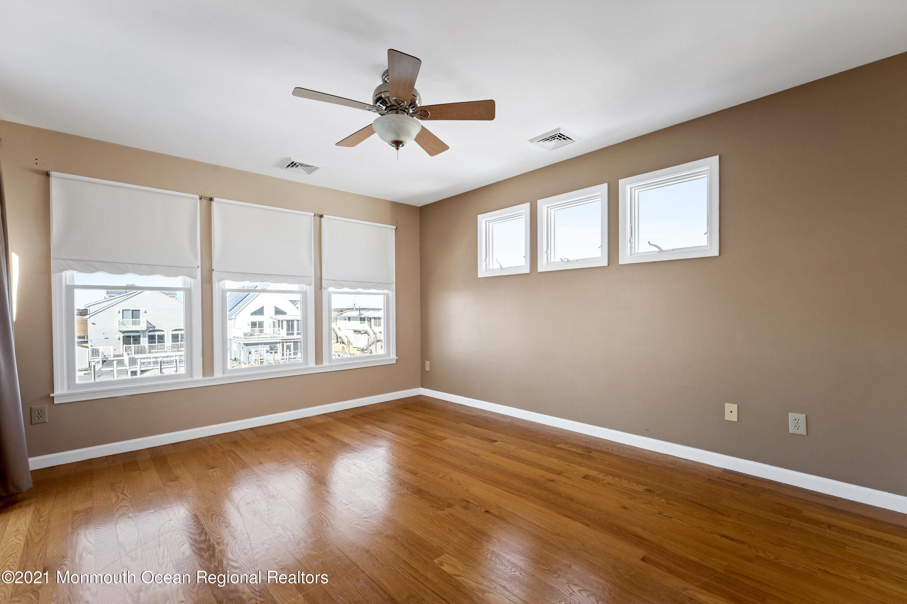 303 Heron Road Tuckerton, NJ 08087 - Photo 16 of 58 a view of an empty room with wooden floor and a window