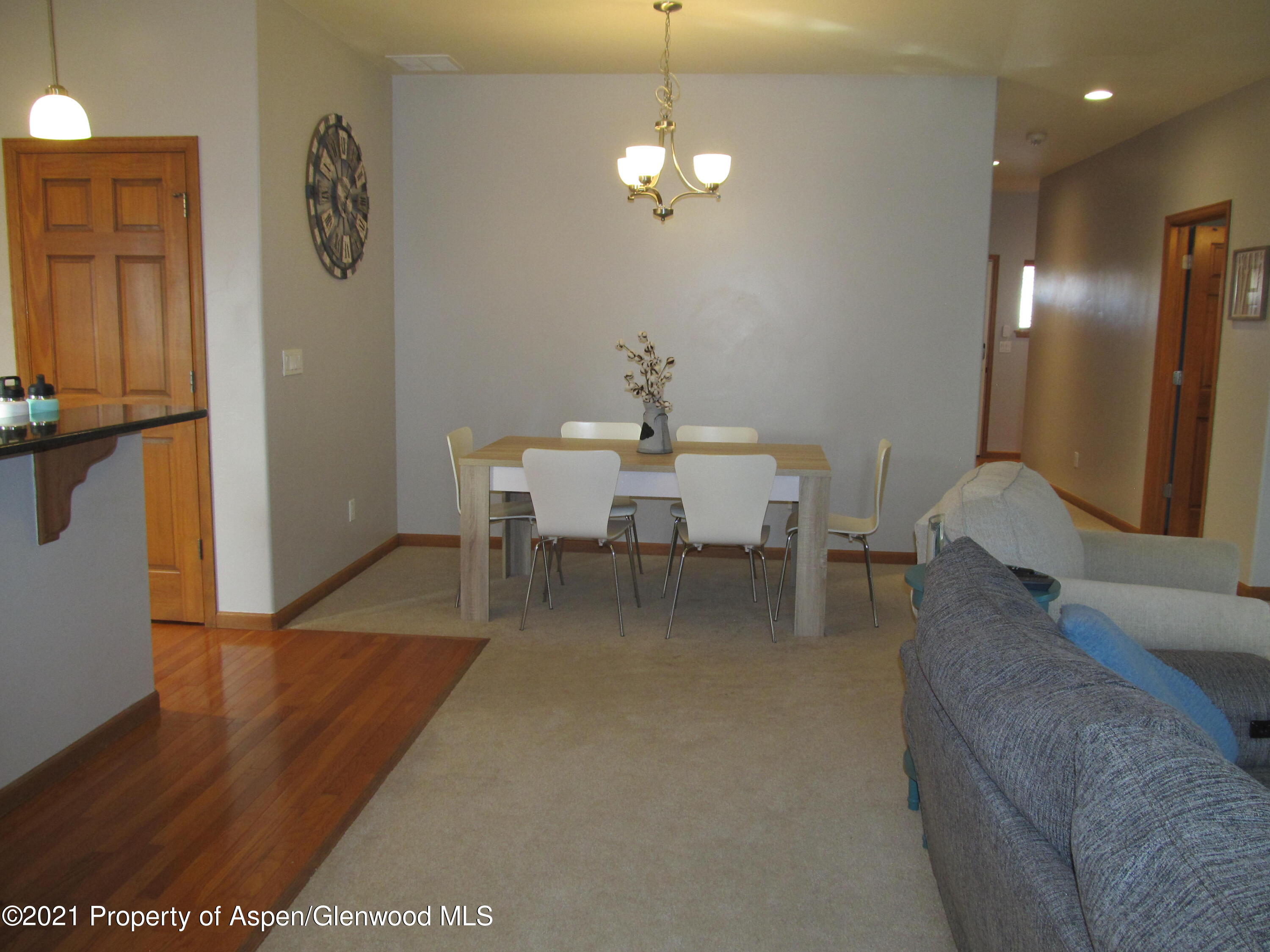 1123 East 19th Street Rifle, CO 81650 - Photo 11 of 37 a dining room with furniture and a chandelier
