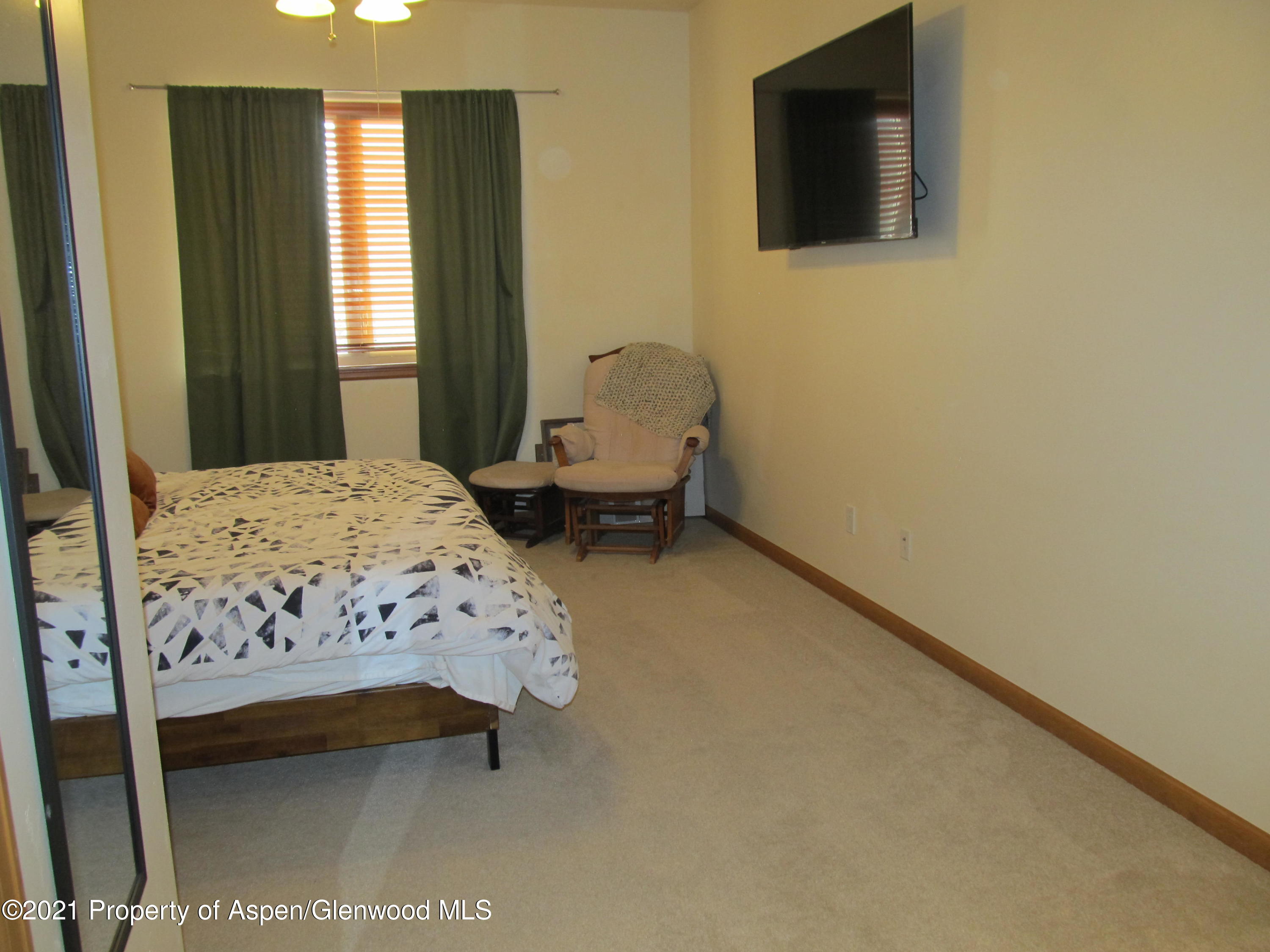 1123 East 19th Street Rifle, CO 81650 - Photo 18 of 37 a bedroom with a bed and wooden floor