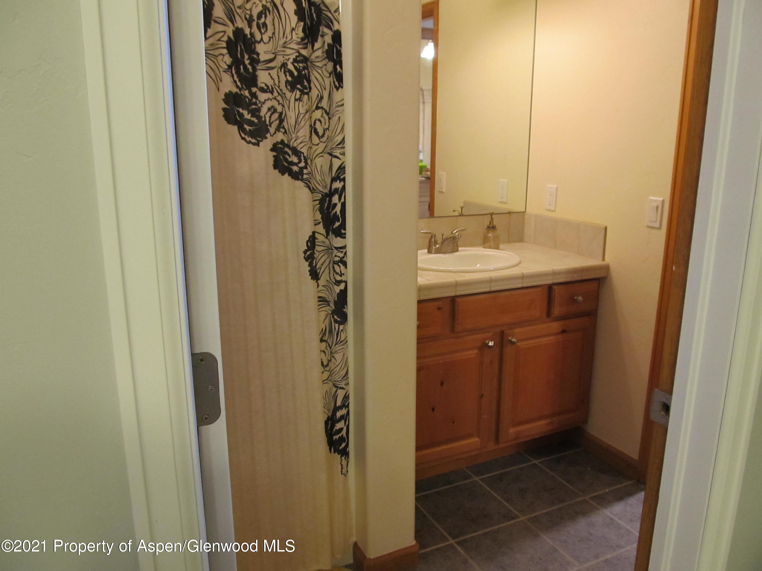 1123 East 19th Street Rifle, CO 81650 - Photo 27 of 37 a bathroom with a shower and a sink