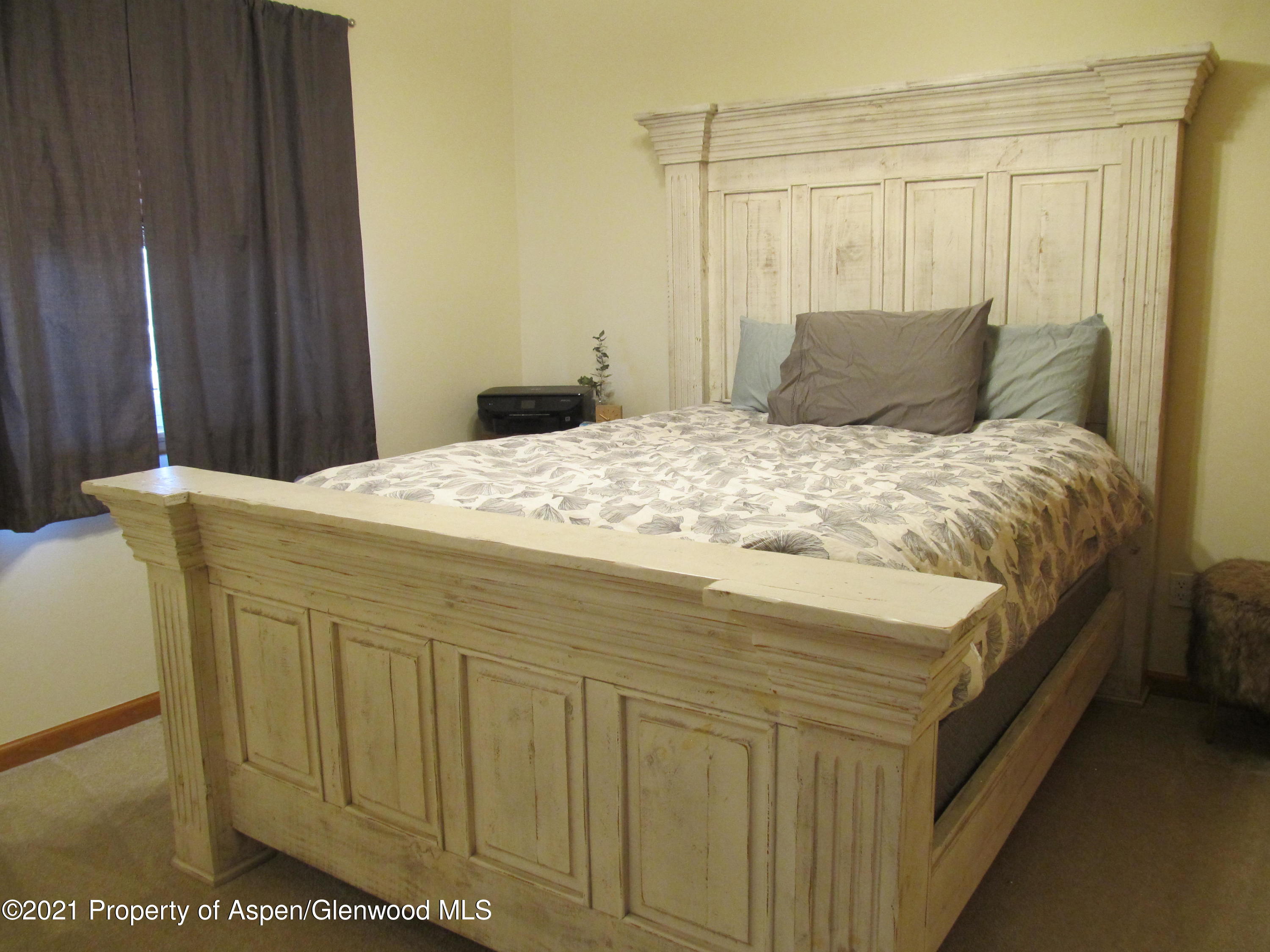 1123 East 19th Street Rifle, CO 81650 - Photo 29 of 37 a bedroom with a bed and a mirror