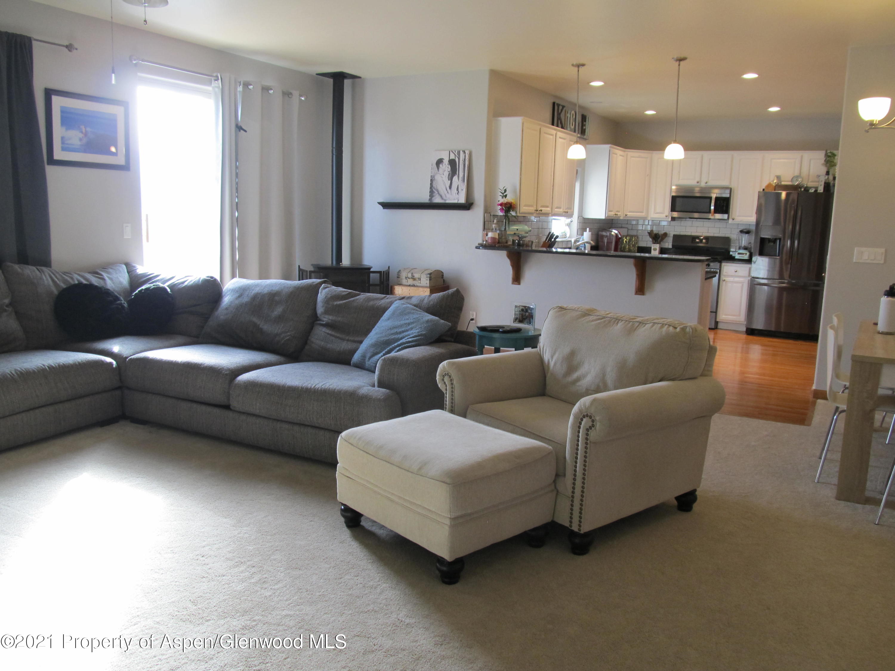 1123 East 19th Street Rifle, CO 81650 - Photo 3 of 37 a living room with furniture and kitchen view