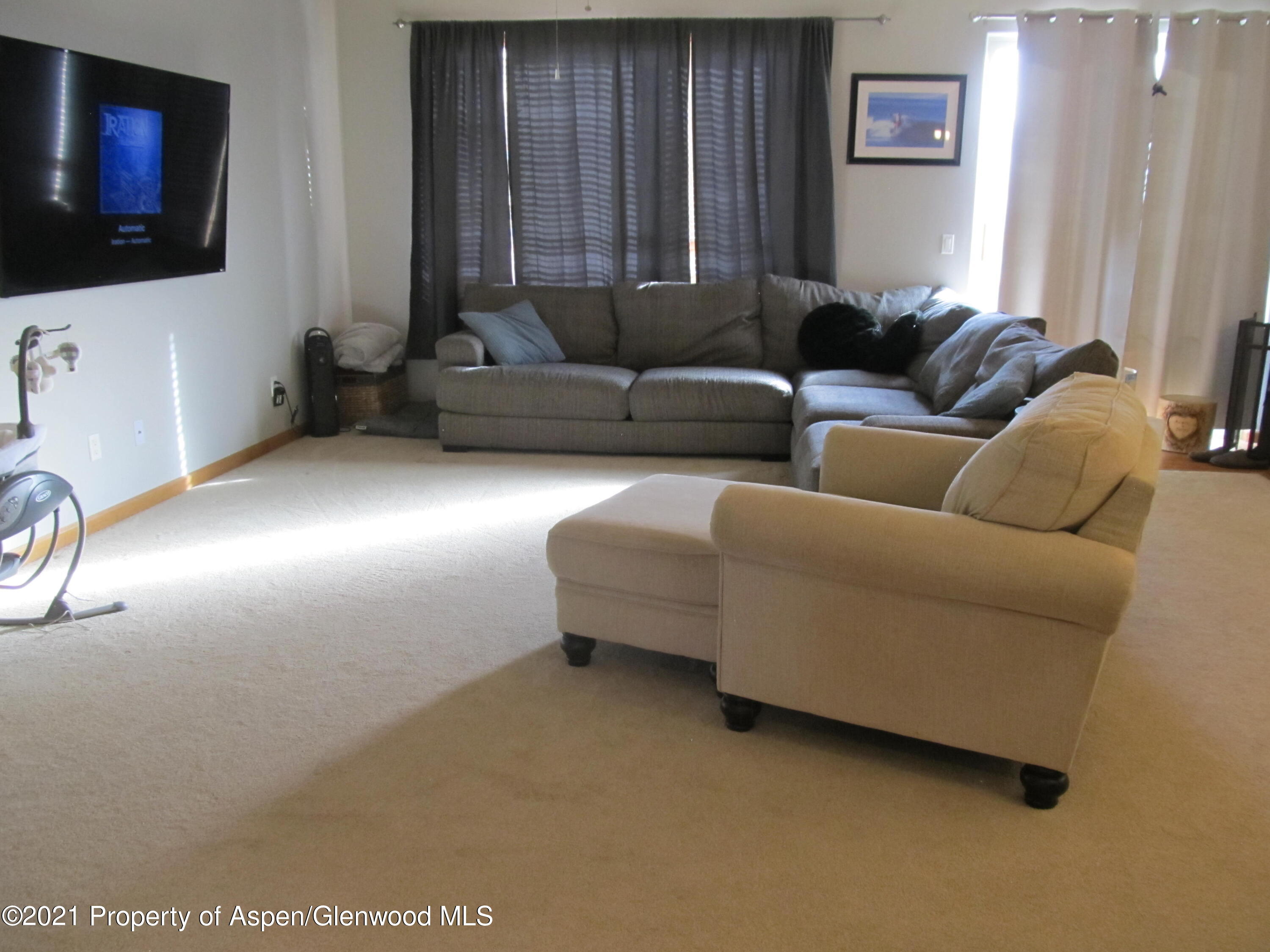 1123 East 19th Street Rifle, CO 81650 - Photo 4 of 37 a living room with furniture and a flat screen tv