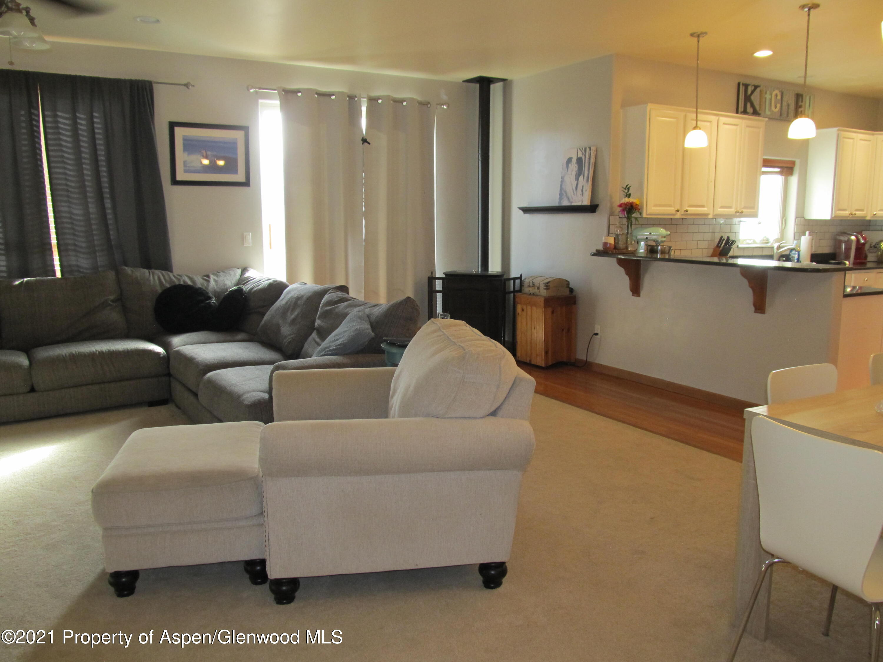 1123 East 19th Street Rifle, CO 81650 - Photo 5 of 37 a living room with furniture and a chandelier