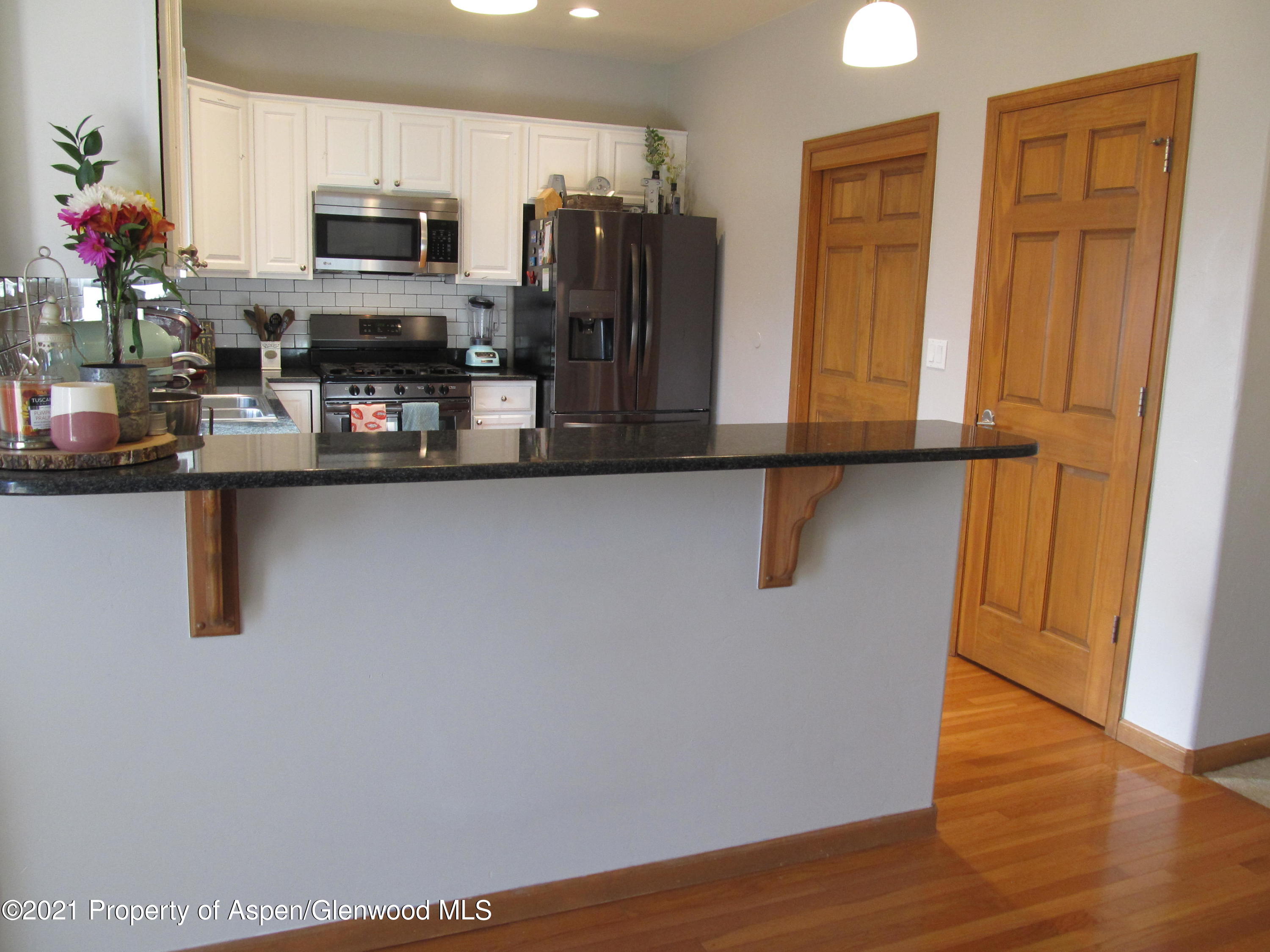 1123 East 19th Street Rifle, CO 81650 - Photo 6 of 37 a kitchen with stainless steel appliances a refrigerator sink and microwave