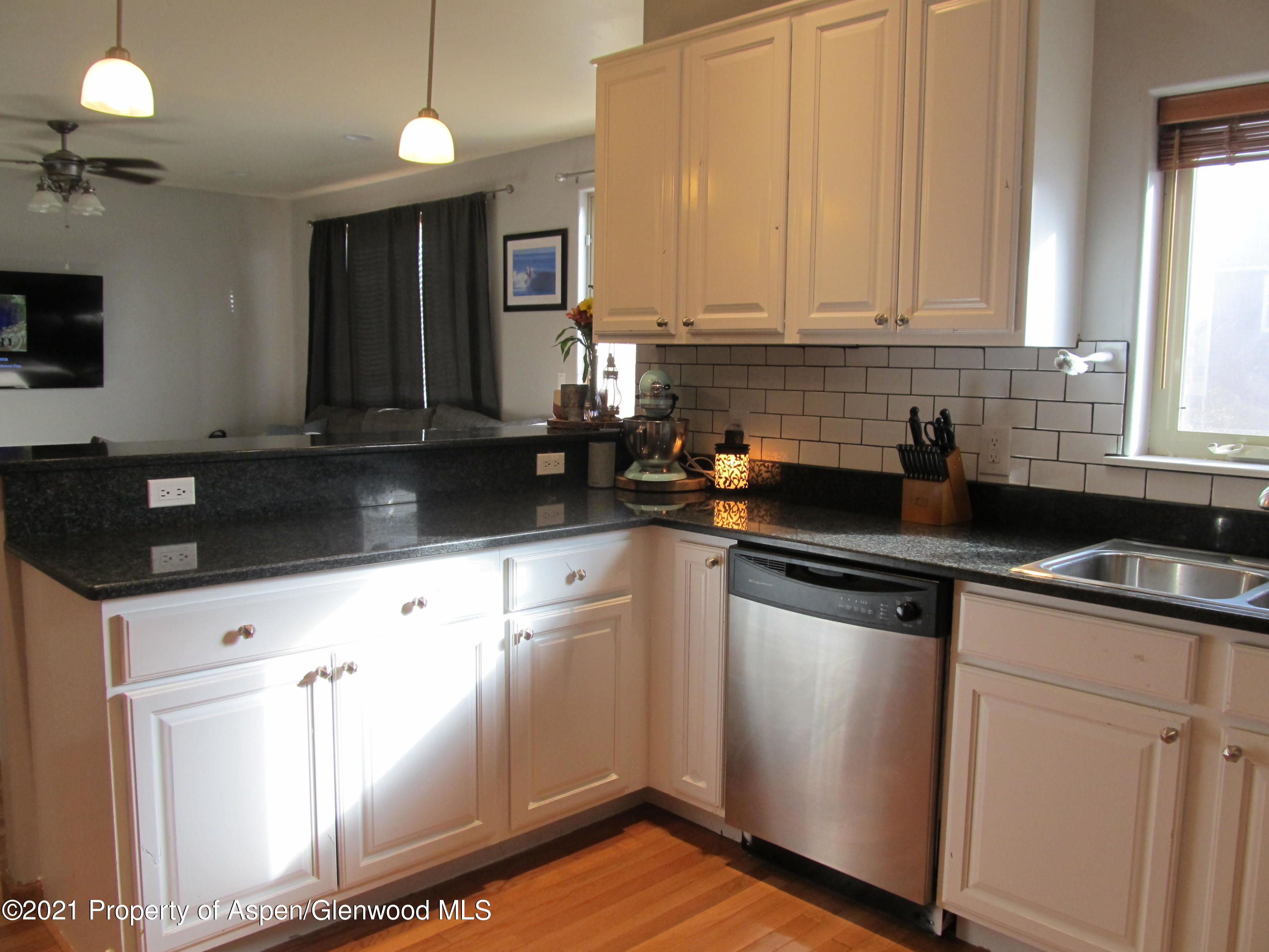 1123 East 19th Street Rifle, CO 81650 - Photo 7 of 37 a kitchen with granite countertop a sink and cabinets
