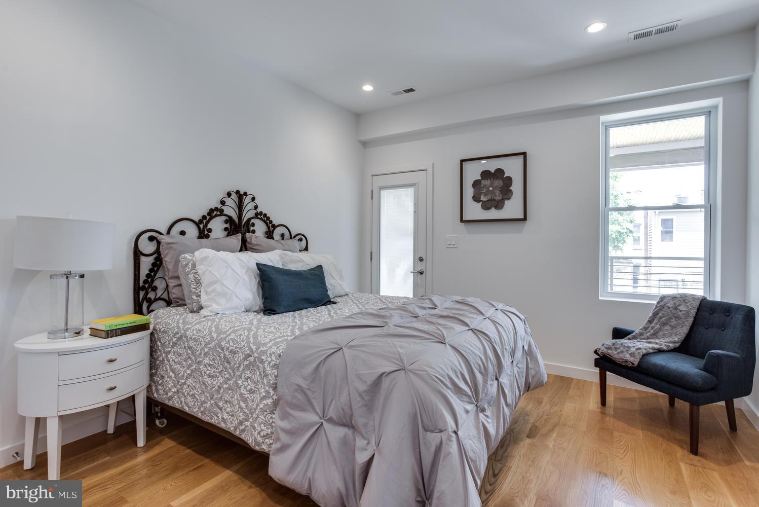 59 Randolph Place Northwest, Unit PH Washington, DC 20001 - Photo 14 of 27 a bedroom with a bed and a chair