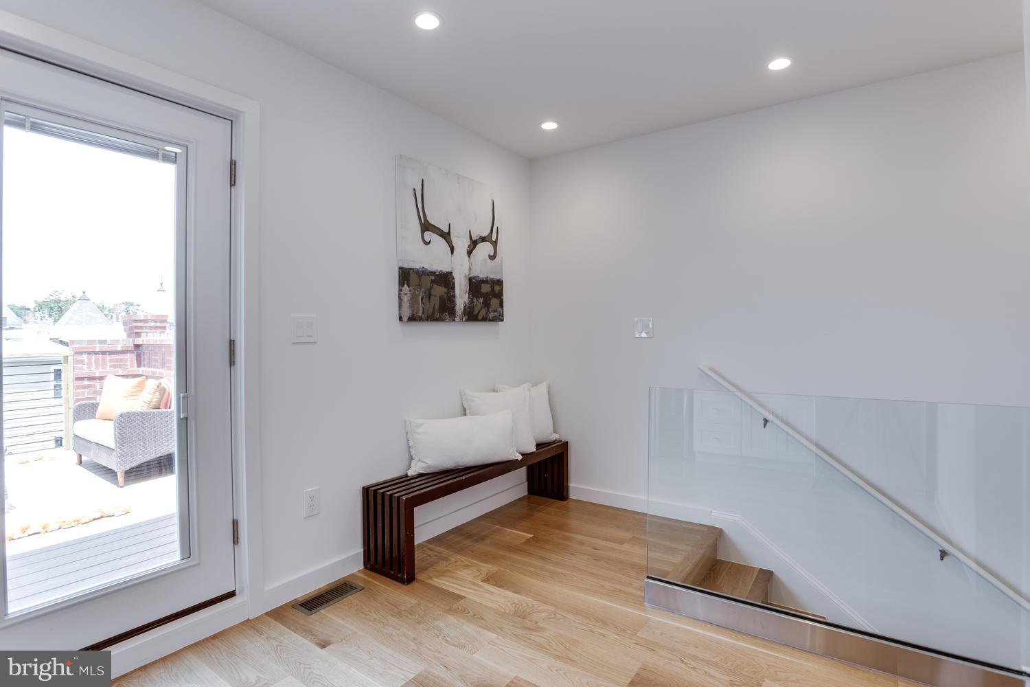 59 Randolph Place Northwest, Unit PH Washington, DC 20001 - Photo 18 of 27 a view of room with window and wooden floor