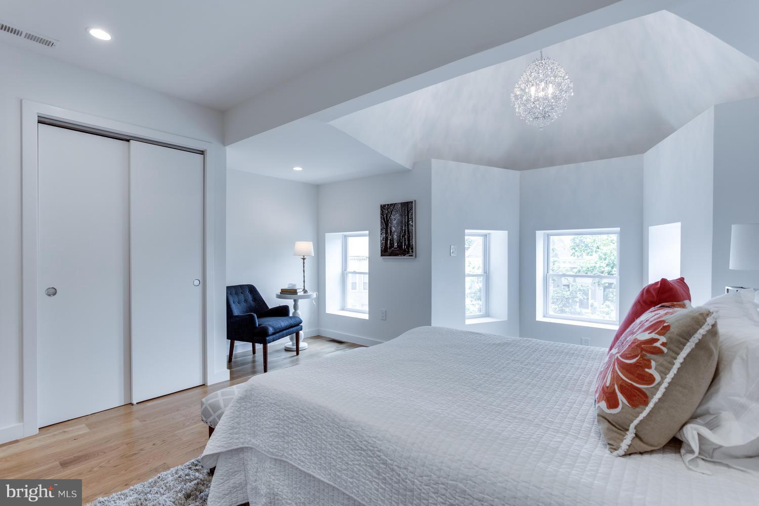 59 Randolph Place Northwest, Unit PH Washington, DC 20001 - Photo 20 of 27 a bedroom with a bed and a chandelier